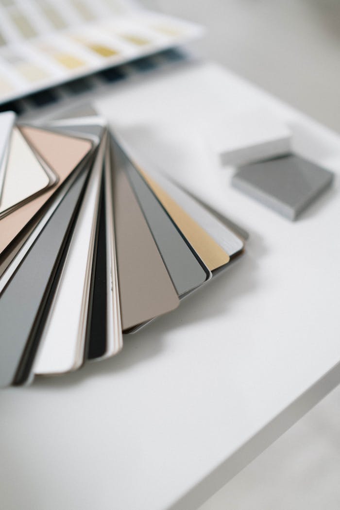 A collection of sleek color swatches on a white table for sophisticated interior design planning.